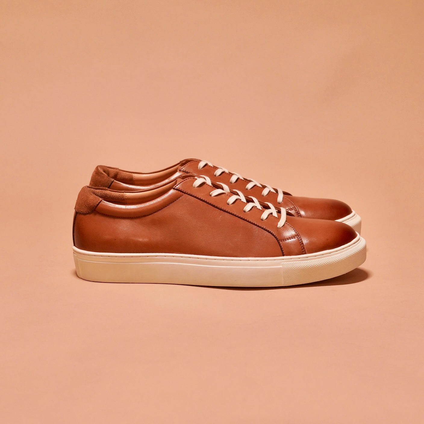 Side view of Bosco tan leather sneakers showcasing the full-grain crust and classic white cup sole.